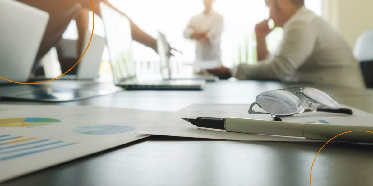 A blurred image of businesspeople in a meeting