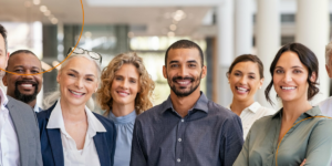 A group of businesspeople smile for a group photo