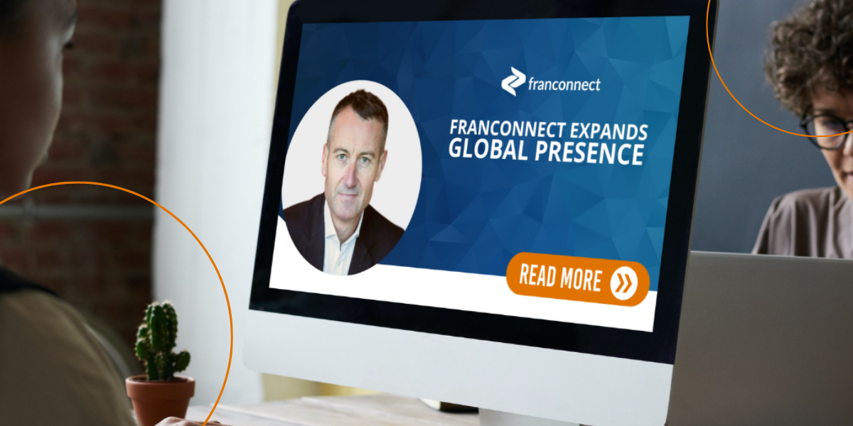 A woman views a desktop that discusses FranConnect's Global Prescence