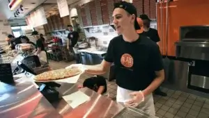 Blaze Pizza Employee serving pizza to a customer